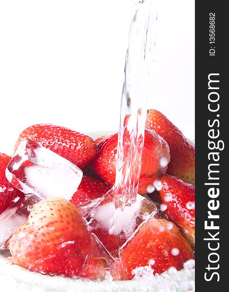 Water and strawberries on white background