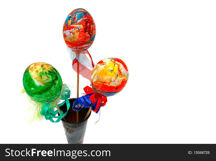 Easter eggs in a glass on a white background