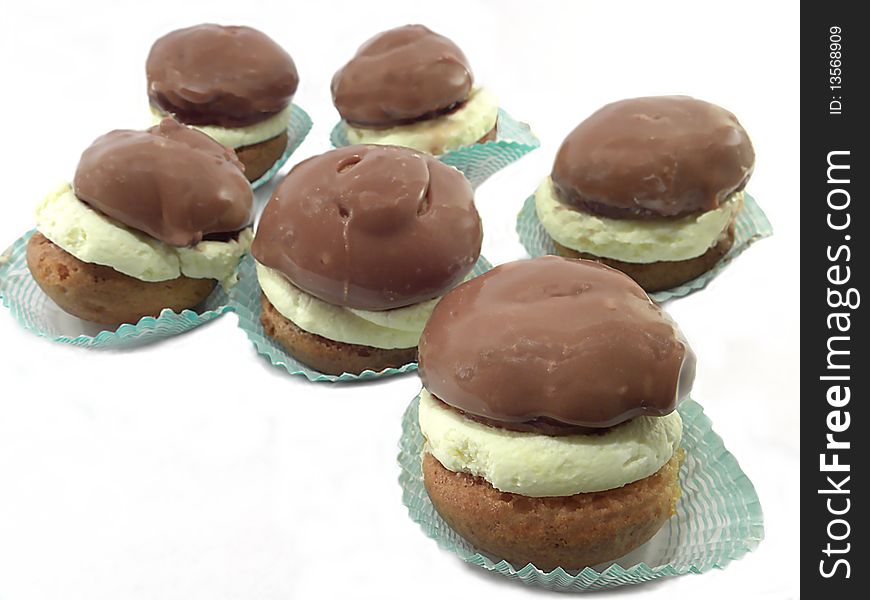 Cakes with cream and chocolate icing , isolated on a white background