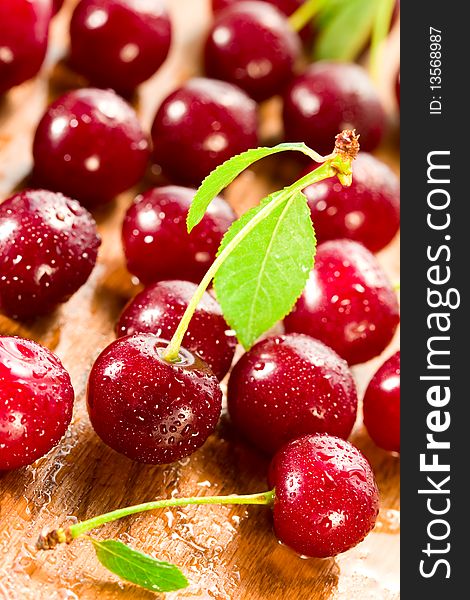 Wet ripe cherries on the wood table. Wet ripe cherries on the wood table