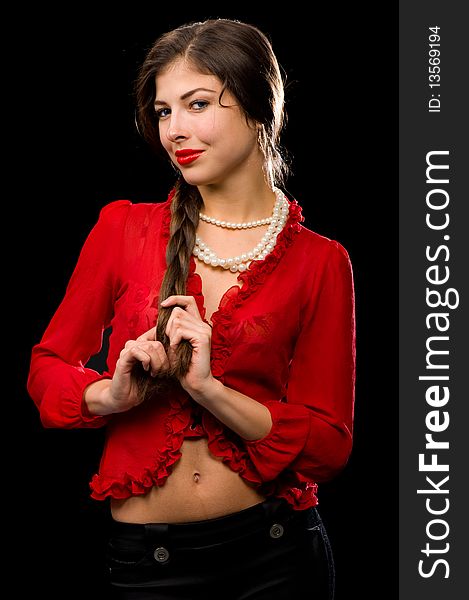 An attractive brunette in a red blouse and red lipstick on her lips, with a pearl necklace around his neck. An attractive brunette in a red blouse and red lipstick on her lips, with a pearl necklace around his neck
