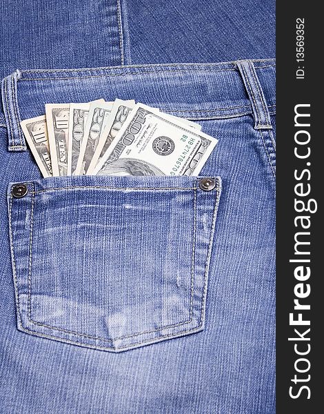U.S. 100, 20 and 10 dollar bills in his back pocket jeans blue. U.S. 100, 20 and 10 dollar bills in his back pocket jeans blue