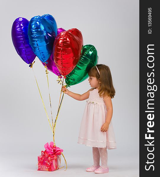 Child in a white dress with balloons. Child in a white dress with balloons