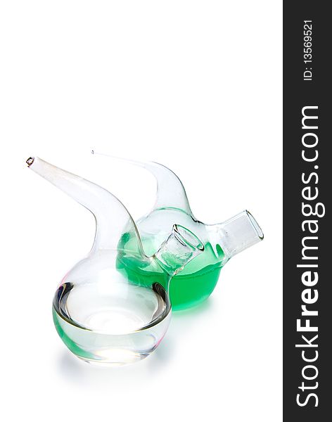 Transparent chemical glassware with green and blue solution isolated on white