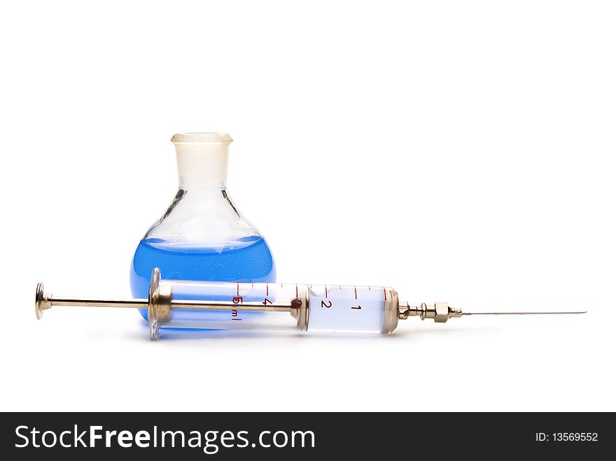 Transparent chemical glassware with blue solution and with syringe isolated on white. Transparent chemical glassware with blue solution and with syringe isolated on white