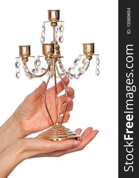 Luxury gold candlestick with precious stones in the woman's hand