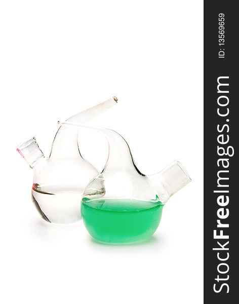 Transparent chemical glassware with green and blue solution isolated on white