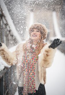 Attractive Woman With Brown Fur Cap And Jacket Enjoying The Winter. Side View Of Fashionable Blonde Girl Posing Royalty Free Stock Image