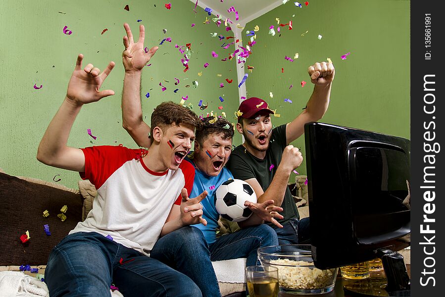 Cheerful family watching soccer cup on television