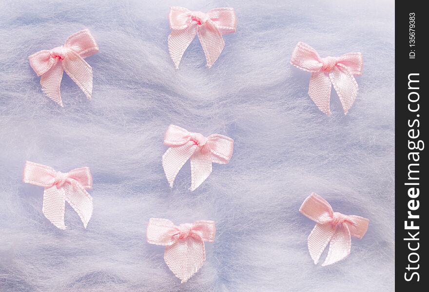 Pink small cute bow on violet background. pink ribbon