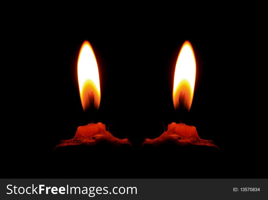 Burning twin candle with darkness around