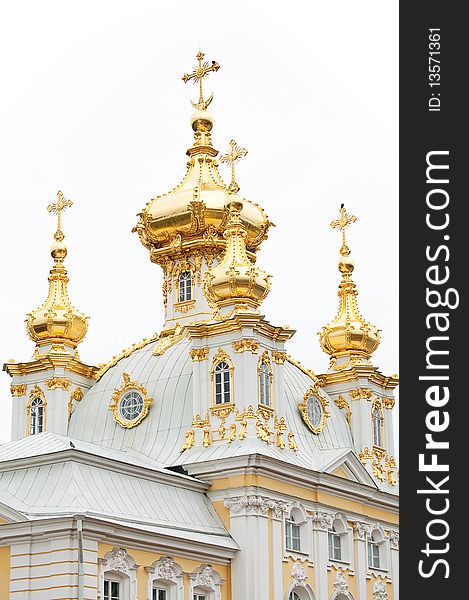 Roof of cathedral with gold decorations on white background