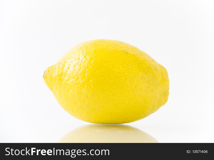 Brightly yellow lemon on a white. Brightly yellow lemon on a white
