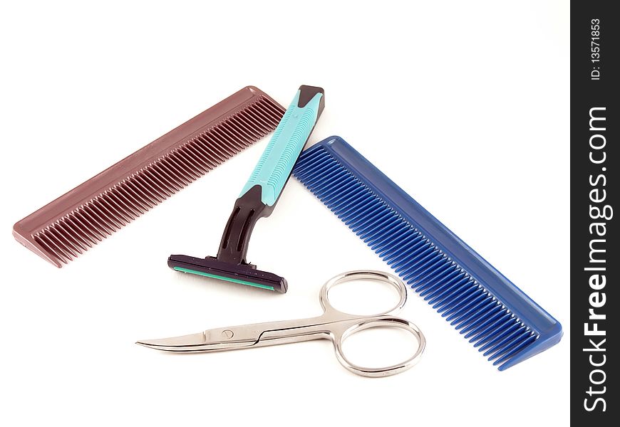 Razor, scissors and combs on the white background.