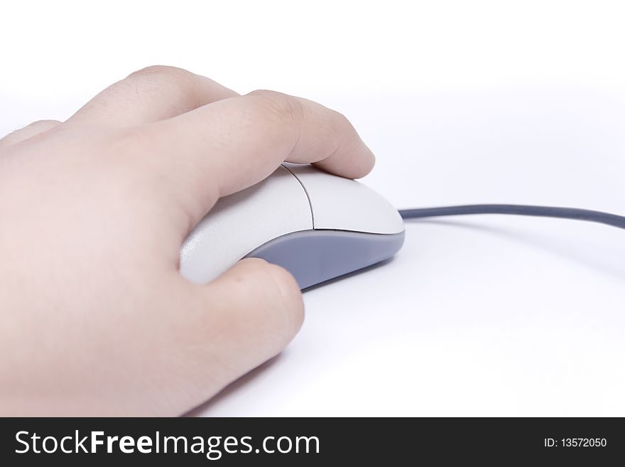 A hand is holding a computer mouse isolated on a white background.