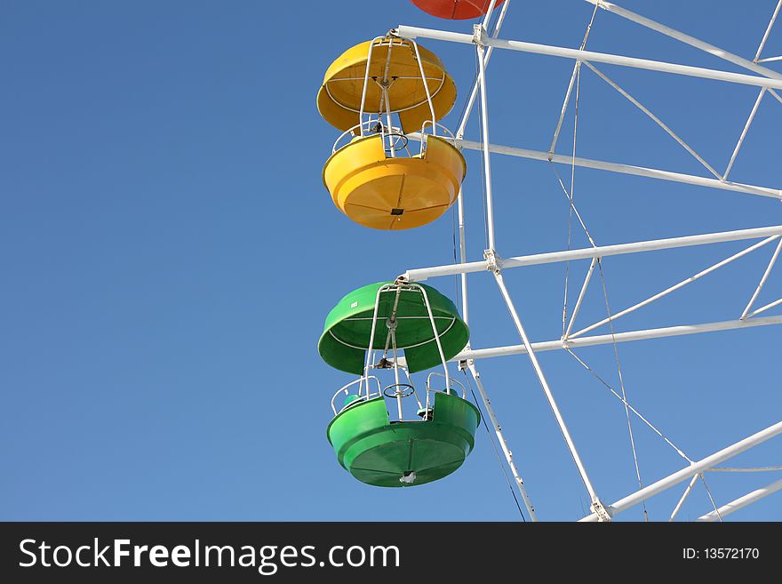 Green And Yellow Cabins Of Ferris Wheel
