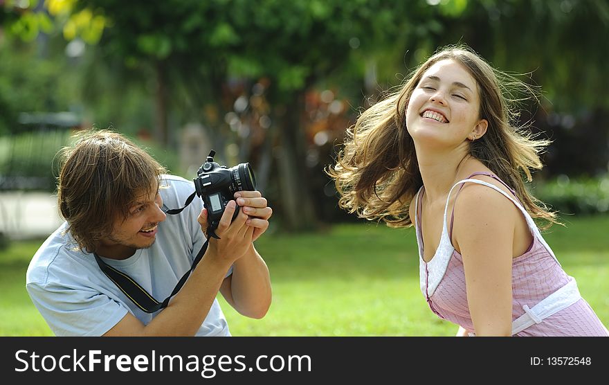 Gorgeous couple take pictures in the park. Gorgeous couple take pictures in the park
