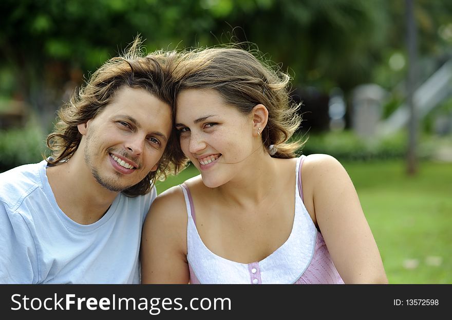 Young couple pose for a portrait outdoors. Young couple pose for a portrait outdoors