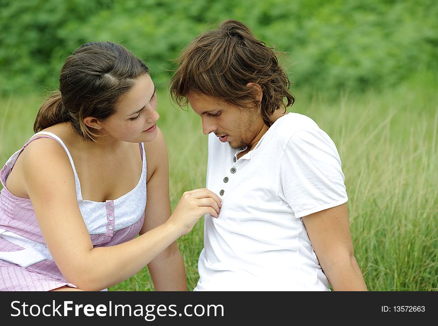 Young couple in love sit together in the park. Young couple in love sit together in the park