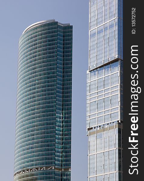 Blue modern office buildings over blue sky