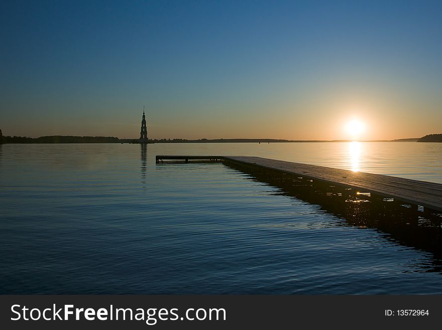 Sunset over Volga river, wooden quay at foreground. Sunset over Volga river, wooden quay at foreground