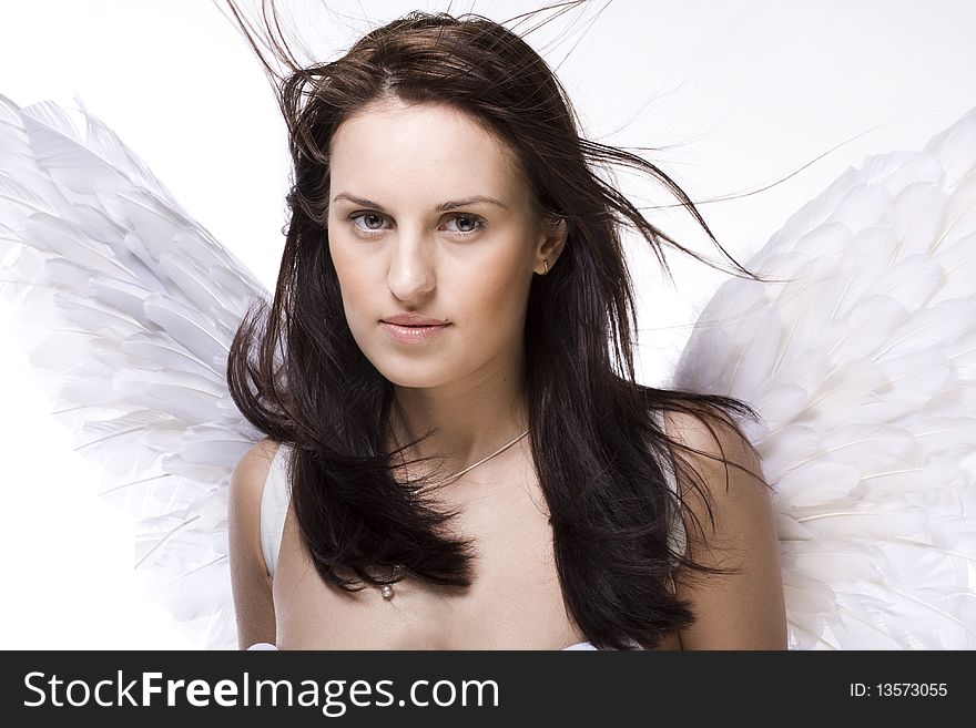 Young  beautiful woman with angel wings and blowing hair. Young  beautiful woman with angel wings and blowing hair