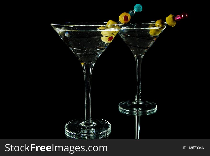 Martinis with olives on a mirror. Martinis with olives on a mirror.