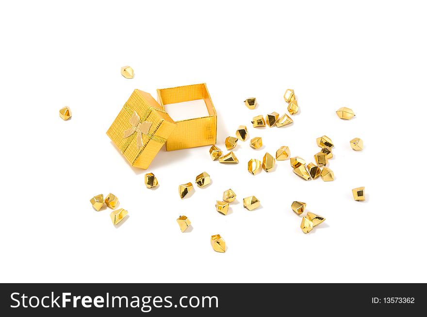 Empty opened golden gift box and golden particles on a white background.