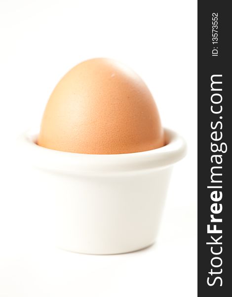 Raw brown egg isolated over white background
