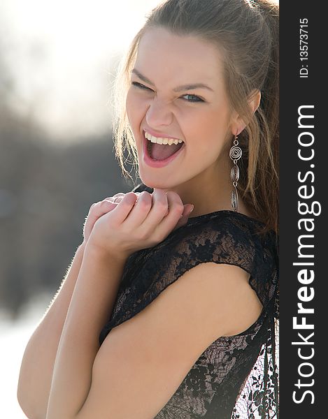 Happy young female smiling while outdoors, close-up portrait