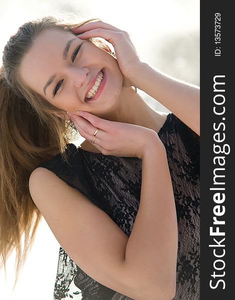 Happy young female smiling while outdoors, close-up portrait