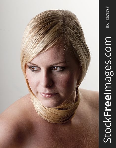 Beauty portrait of a young woman with her hair around neck.