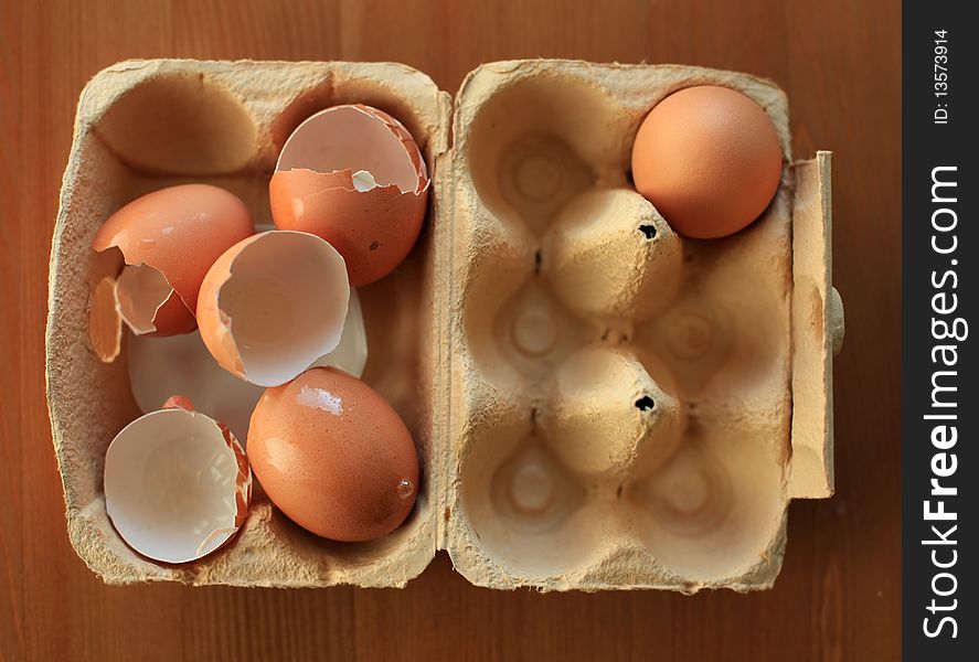 Closeup on eggs in carton with one egg left and the rest used empty. Closeup on eggs in carton with one egg left and the rest used empty