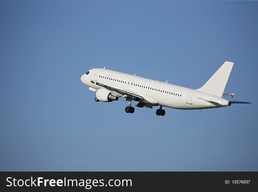 Airliner taking off in a blue sky