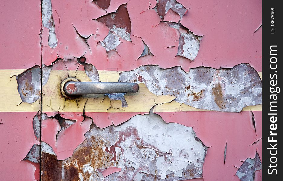 Old red painted steel door texture with metal lever
