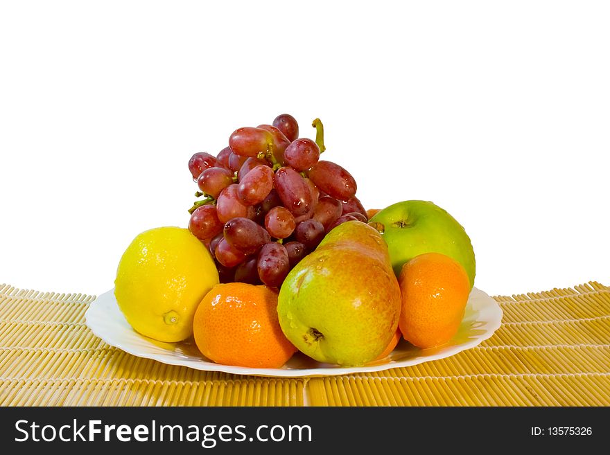 Ripe Fruits In Plate On Table