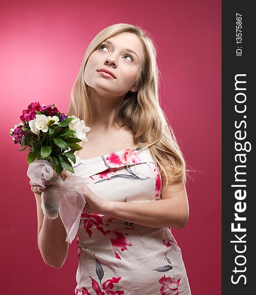 Studio portrait of a beautiful girl with pink flowers