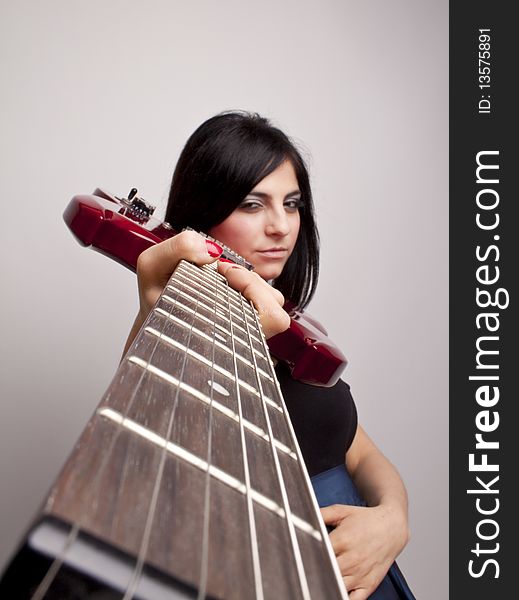 Woman looking down the neck of the  Guitar . Woman looking down the neck of the  Guitar .