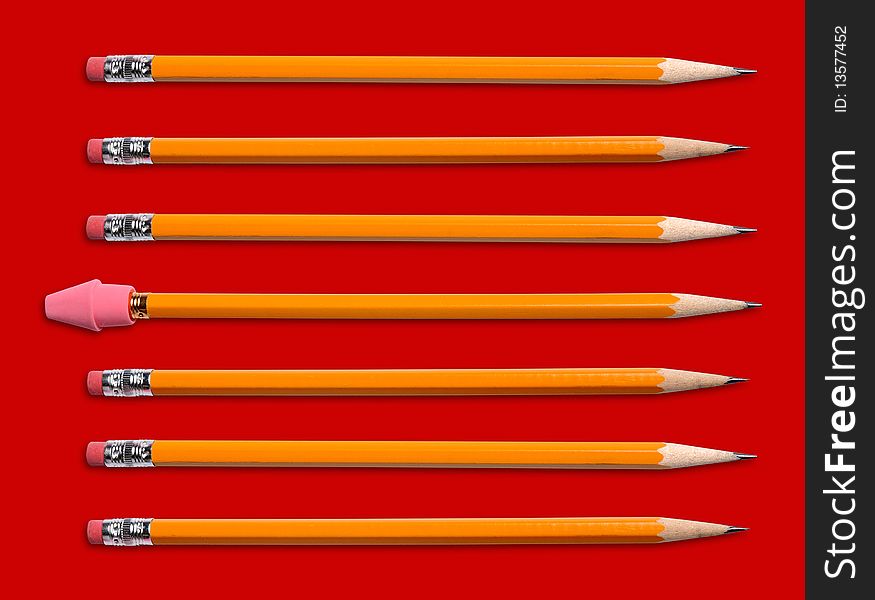 Yellow pencils with two different kinds of erasers isolated over red. Yellow pencils with two different kinds of erasers isolated over red