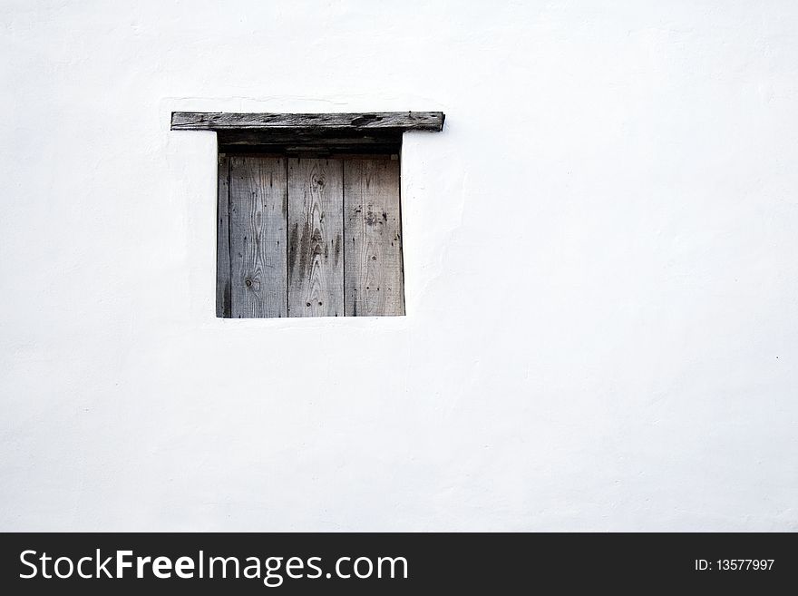 Square wooden window on a white wall. Square wooden window on a white wall