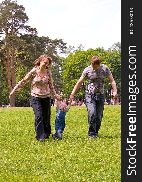 Happy family with son walking outdoors