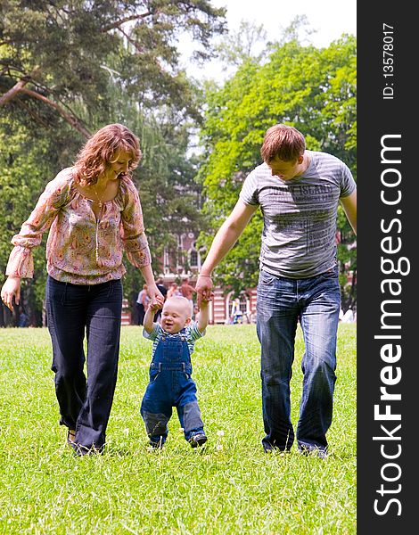 Happy family with son walking outdoors