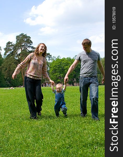Happy family with son walking outdoors