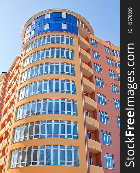 Large modern colored building at the sky background. Large modern colored building at the sky background.