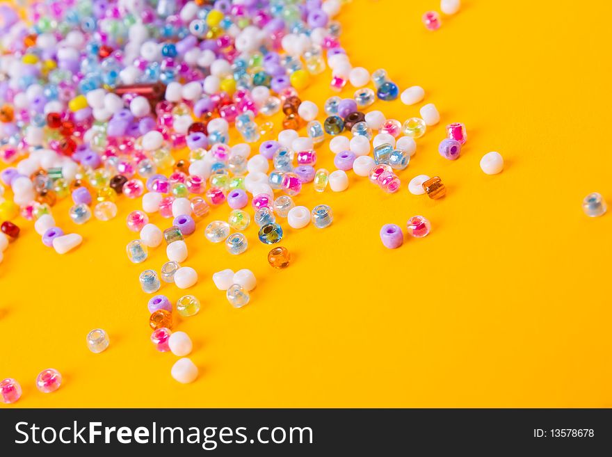 Beads on yellow background. Abstract. Beads on yellow background. Abstract