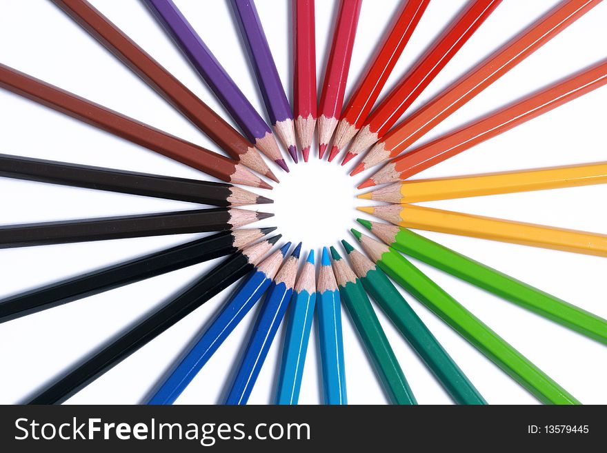 Assortment of colored pencils with shadow on white background - colored crayons