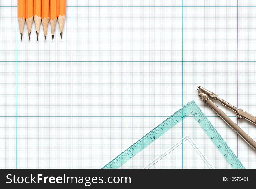 Divider, pencils and ruler on blue graph paper background. Divider, pencils and ruler on blue graph paper background