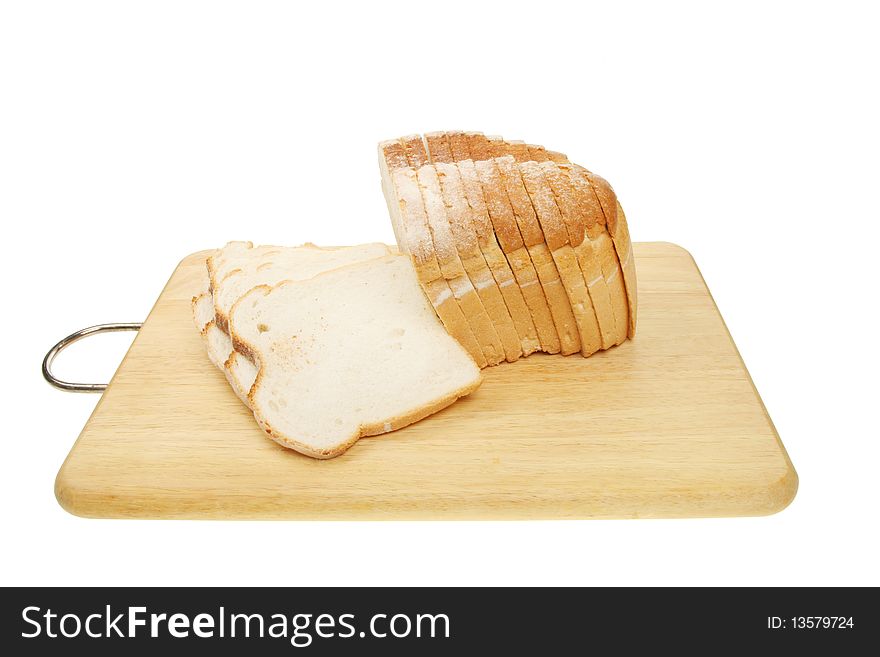 Loaf of sliced crusty white bread on a board. Loaf of sliced crusty white bread on a board