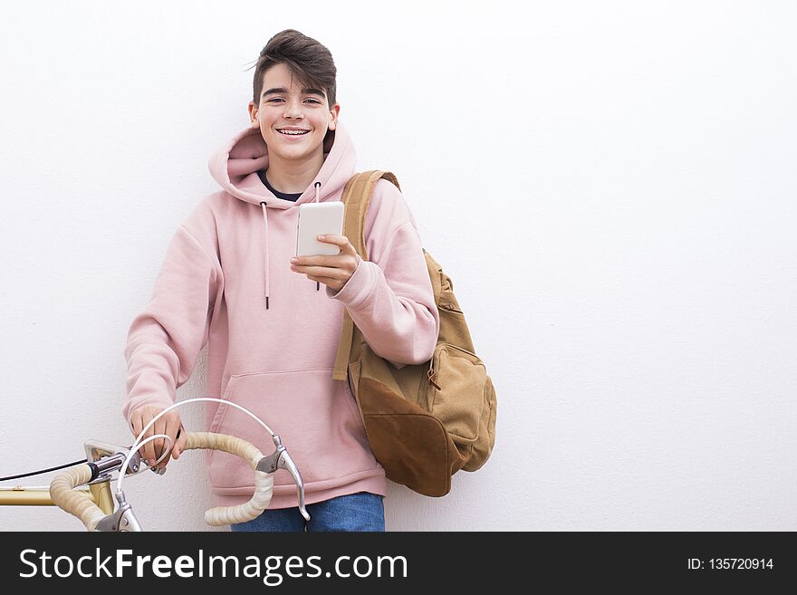 Young student with backpack and bicycle