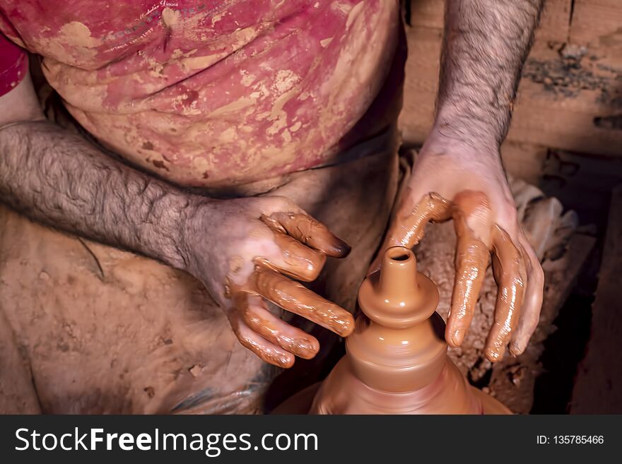 Professional Potter Making Bowl In Pottery Workshop, Studio